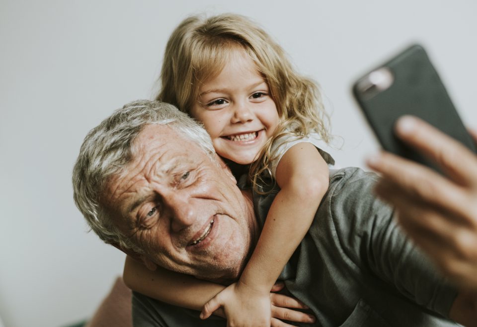 Grandfather taking a selfie with his granddaughter